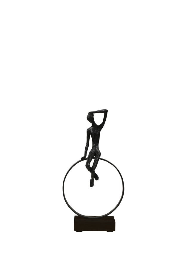 Sculpture - Figure sitting on a ring